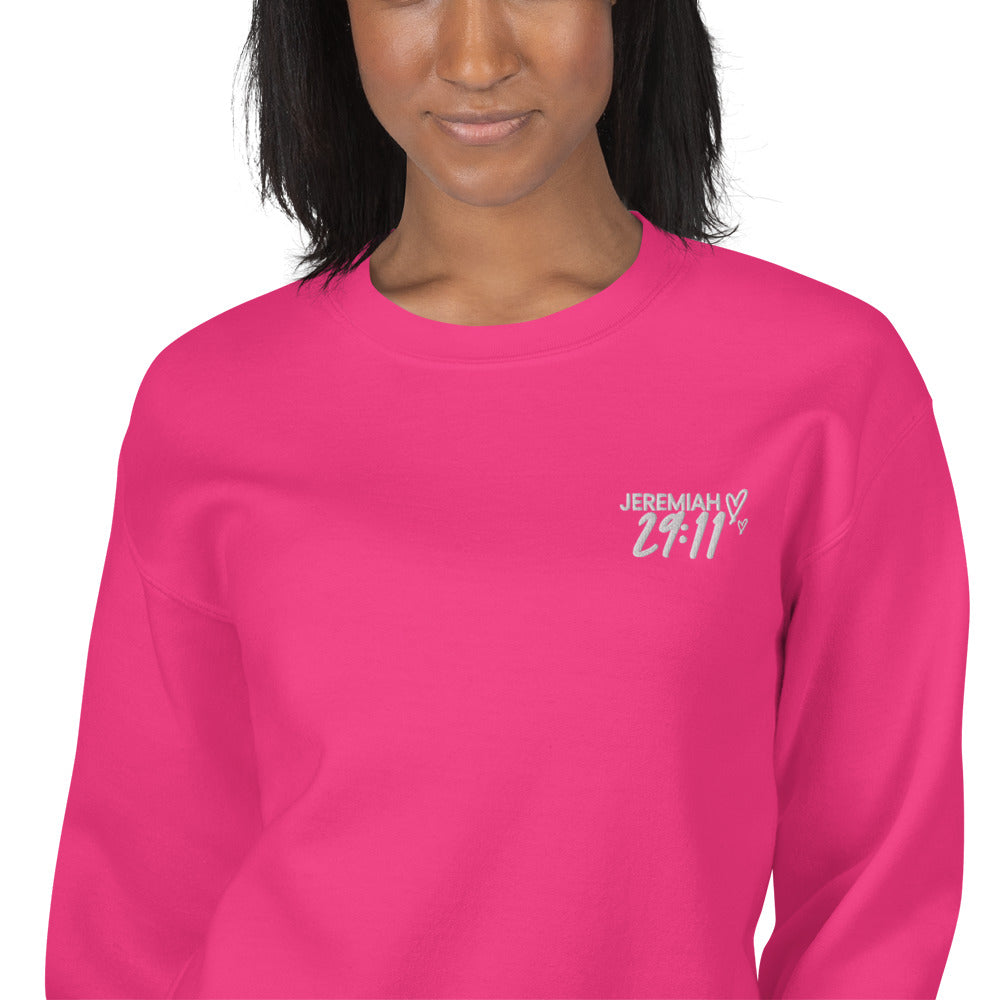 Pink crewneck with white embroidered Jeremiah 29:11 on leftt corner 