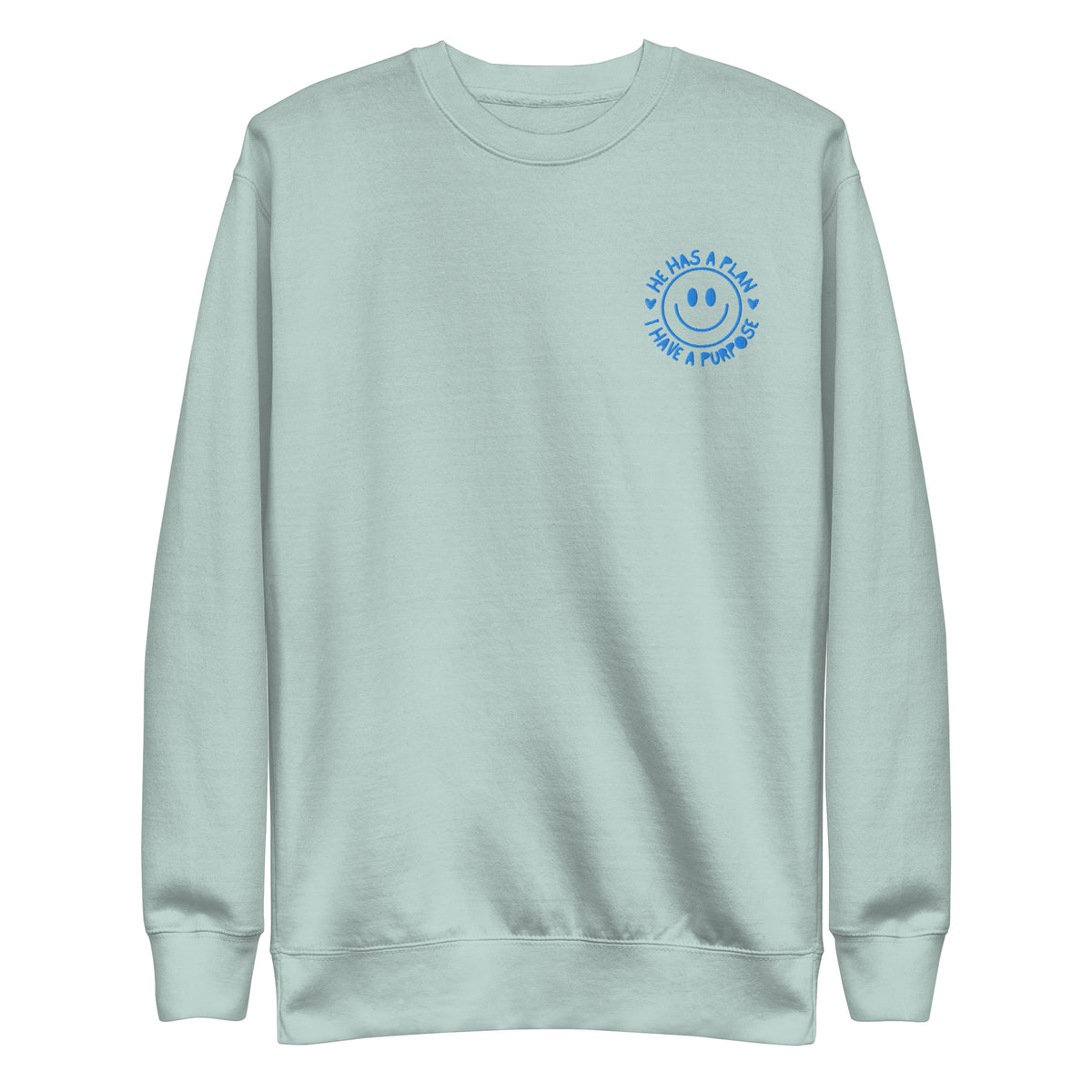 Light blue sweatshirt with an embroidered smiley face design that reads hee has a plan, I have a purpose on a white background